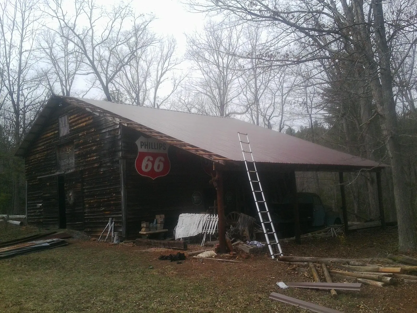 New metal roof on an open sided timber barn with a vintage sign in Kenly